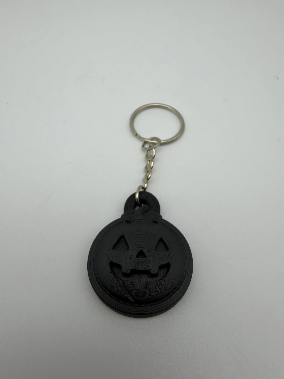 Black 3D printed jack o lantern keychain